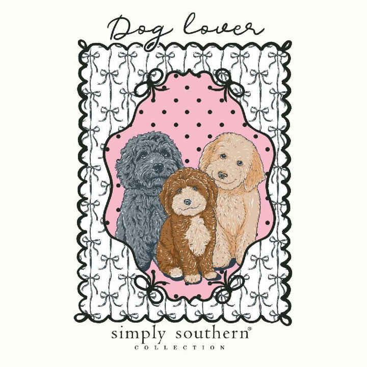 Close up of trio of doodle dogs in black brown cream with black white bow border detail