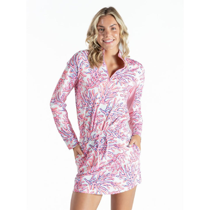 Woman wearing Simply Southern coral UPF 50 quarter-zip pullover and matching skort