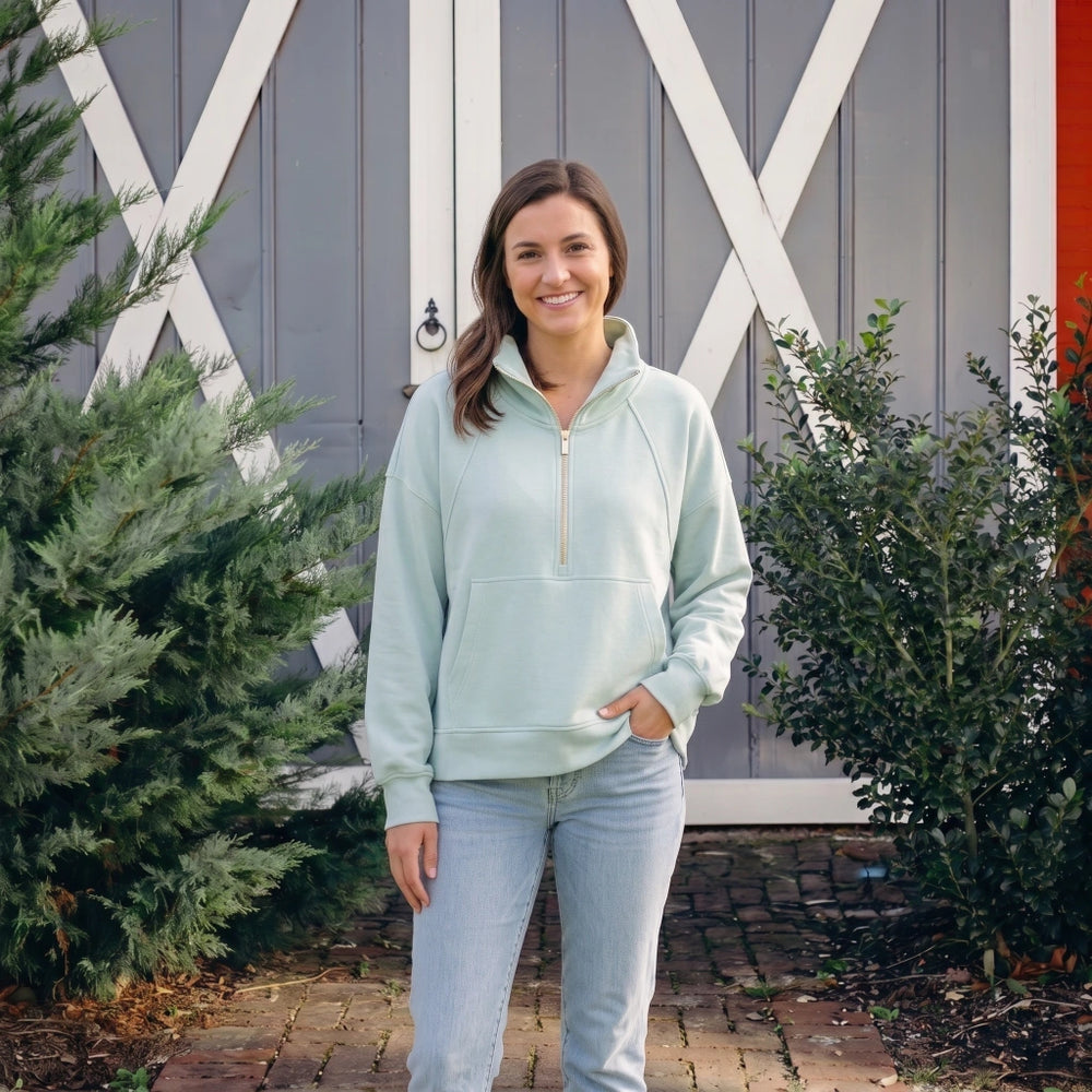 Simply Southern Harbor quarter-zip pullover in mint green with light wash jeans, styled outdoors in front of a barn door