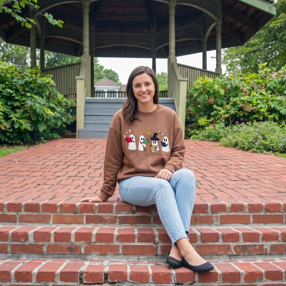 Simply Southern Fall Ghost embroidered crewneck sweatshirt in brown with cute ghost graphic, styled with light wash jeans at an outdoor gazebo