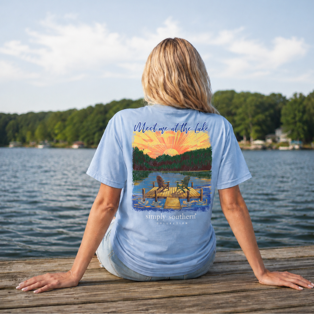 Woman wearing faded blue Simply Southern lake life mineral wash tee with sunset dock graphic
