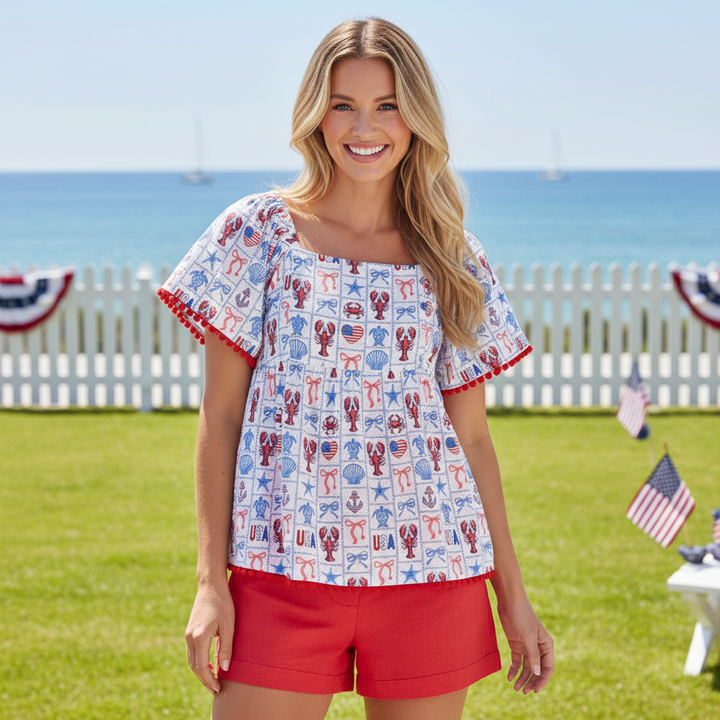 Woman wearing Simply Southern patriotic Americana top with lobster print and red shorts for Fourth of July