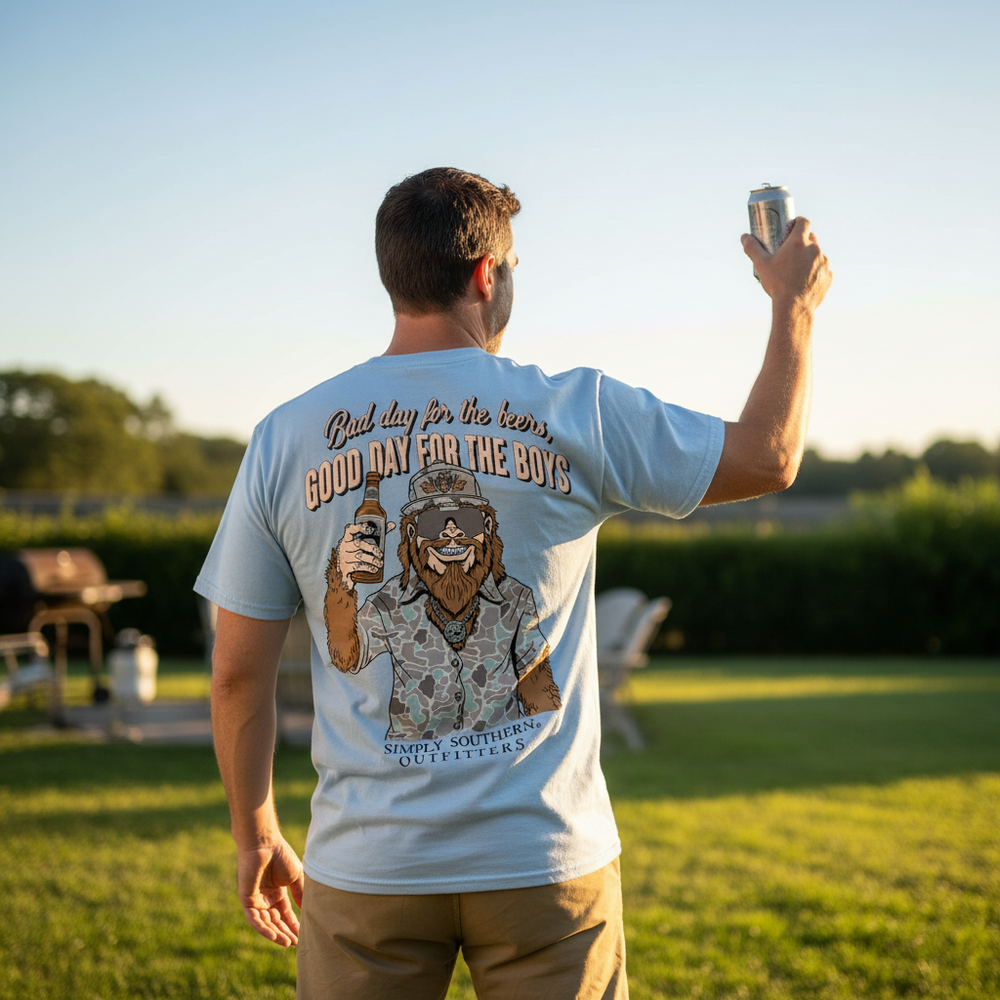 Man wearing Simply Southern Bigfoot beer tee with Sasquatch camo graphic at BBQ
